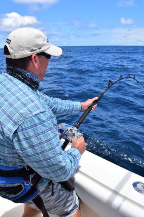Angler fighting hooked marlin