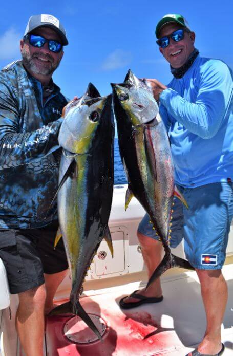 Anglers posing with yellowfin tunas