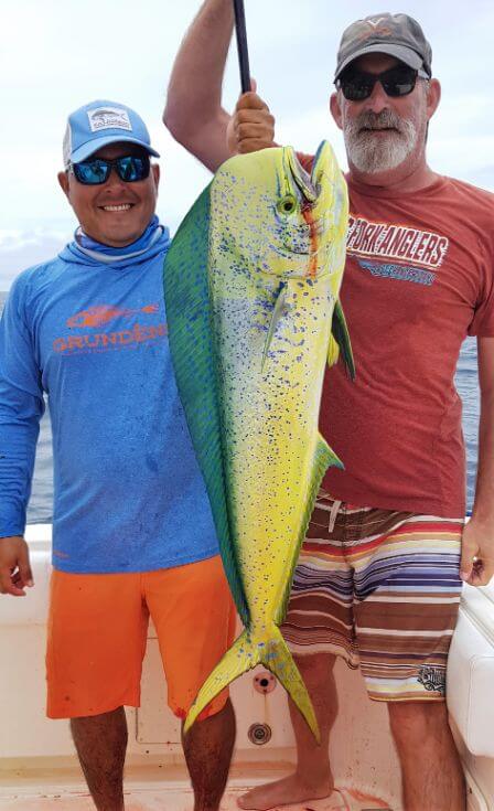 Mate Juan and angler posing with Dorado, also known as ‘Mahi-Mahi’ or ‘Dolphin’