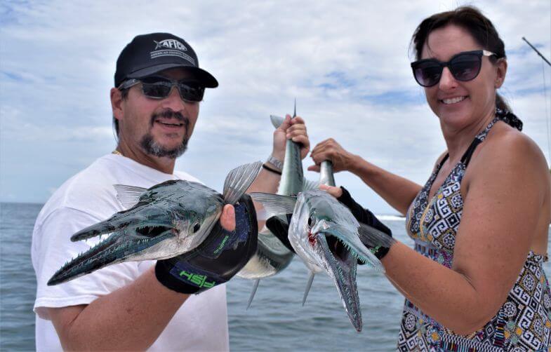 The Warners posing with needlefish.