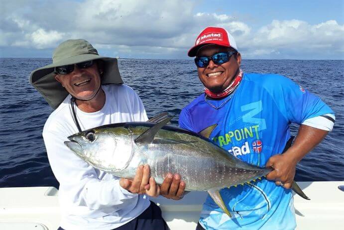 Mate and angler posing with small yellowfin tuna