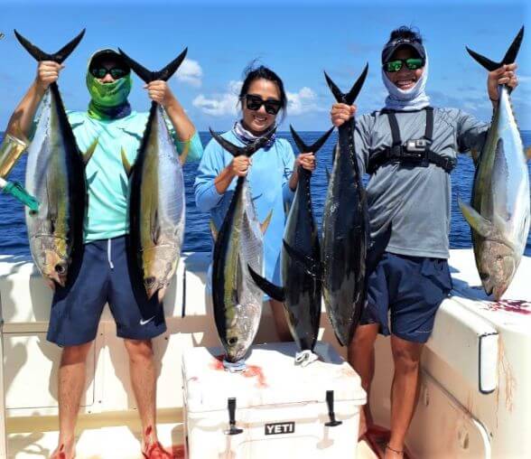 Anglers posing with yellowfin tunas
