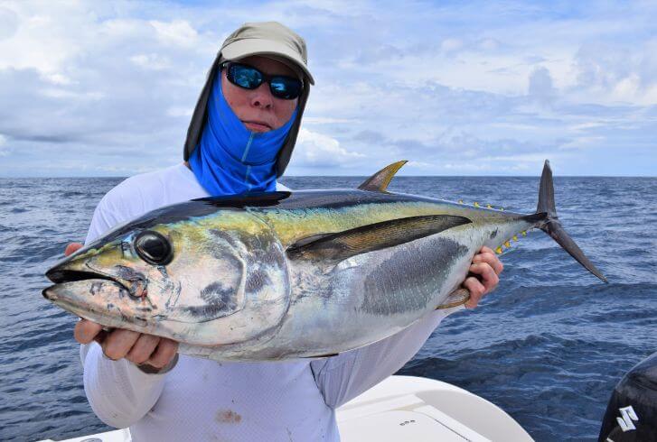 Angler posing with yellowfin tuna
