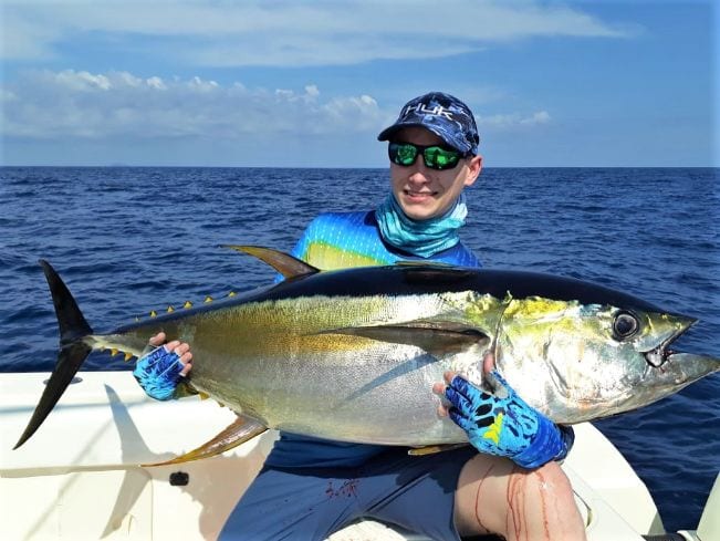 Junior angler holding large yellowfin tuna