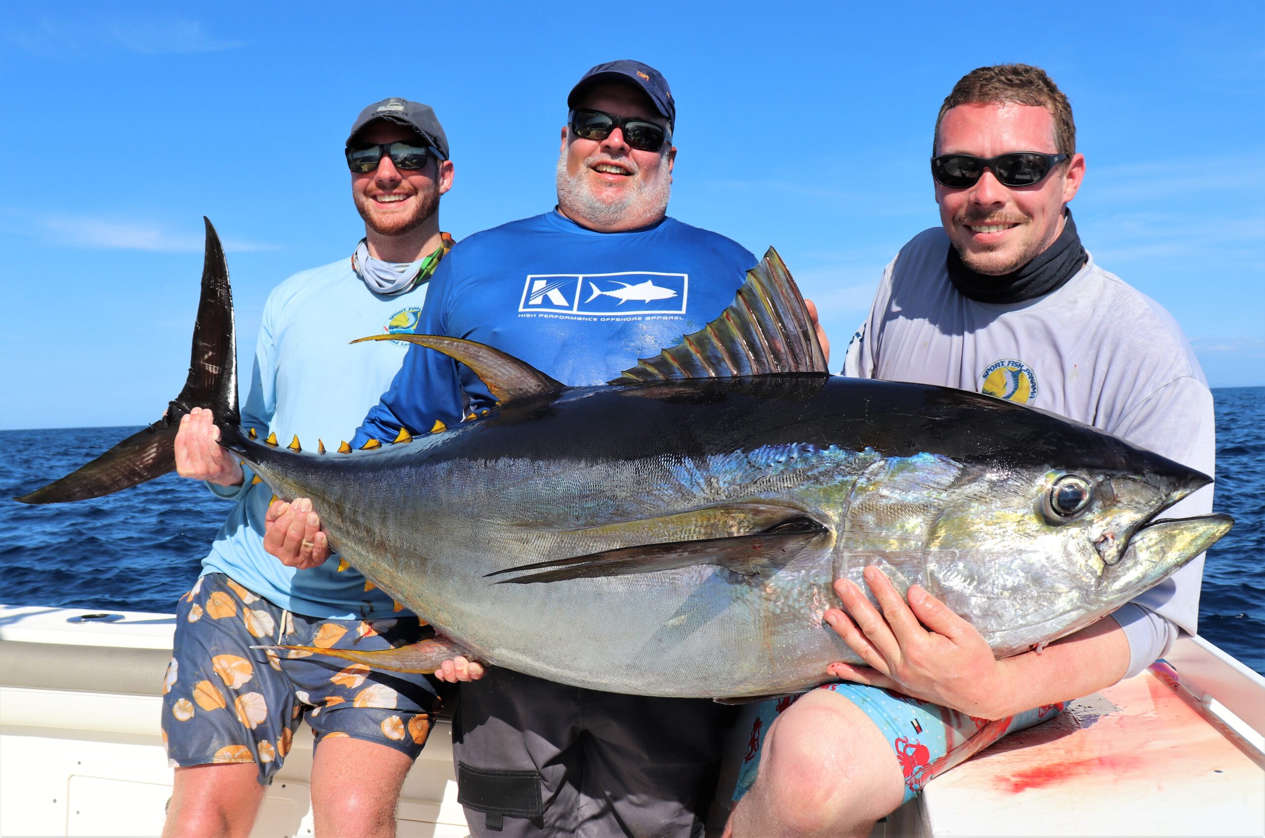 3 anglers holding large tuna for bragging picture