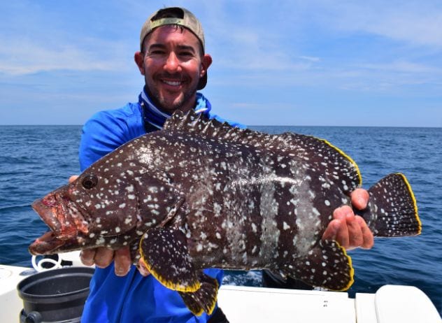 Angler posing with a Leather Bass