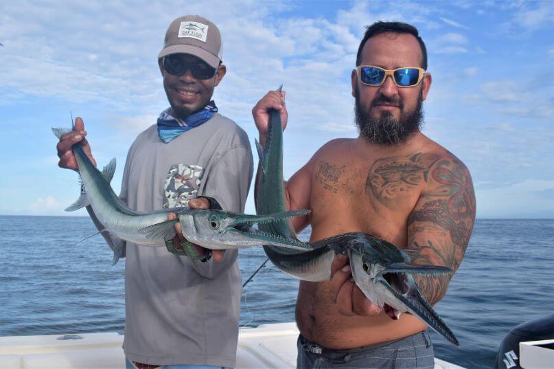 Mate and angler posing with needlefish