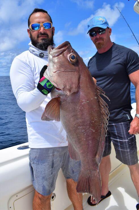 Angler holding amberjack
