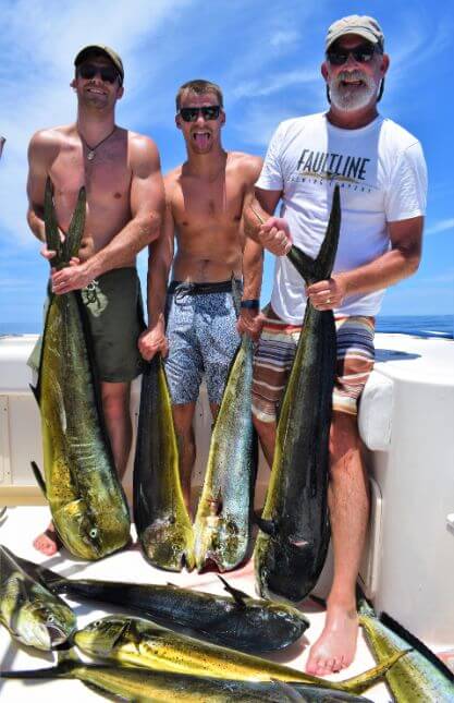 Anglers showing off with large catch of Dorado, also known as ‘Mahi-Mahi’ or ‘Dolphin’