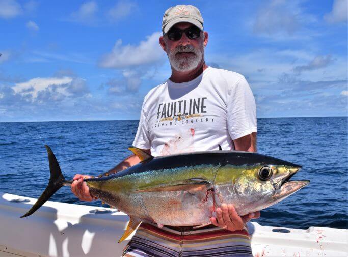 angler posing with Yellowfin tuna... Sport Fish Panama Island Lodge