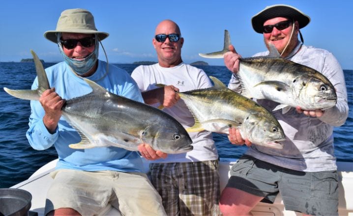 Anglers holding jacks while inshore fishing in Panama