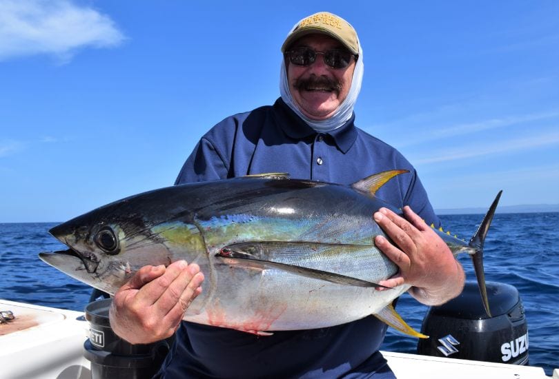 Angler posing with a small yellowfin tuna