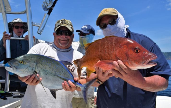 Two anglers posing with a Bluefin Trevally and small cubera snapper