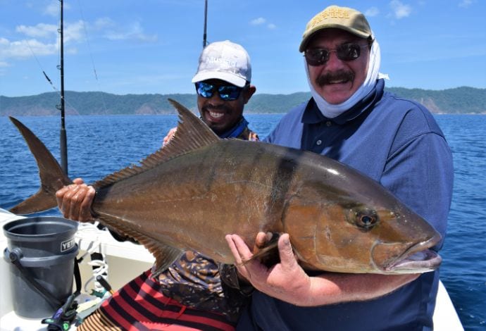 Mate holding snapper with Isla Parida in background