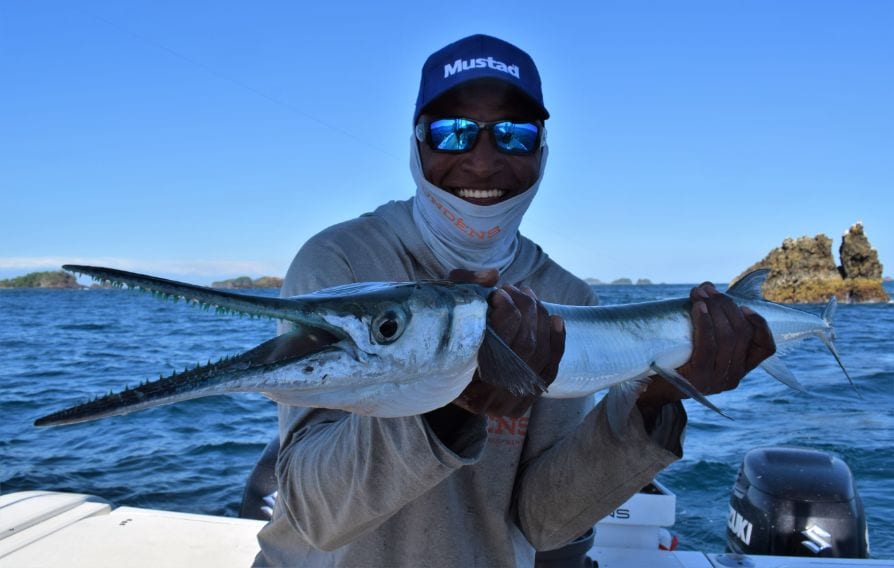 Mate holding a needlefish