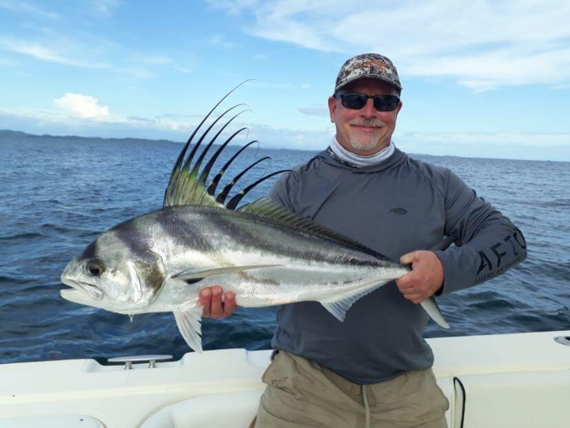Angler posing with roosterfish. Isla Parida, Panama in the background.