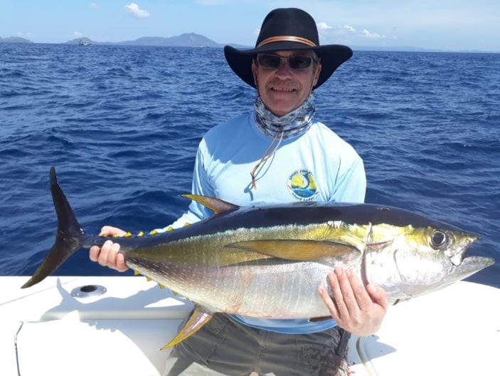 Smiling angler holding 40 pound Yellowfin tuna