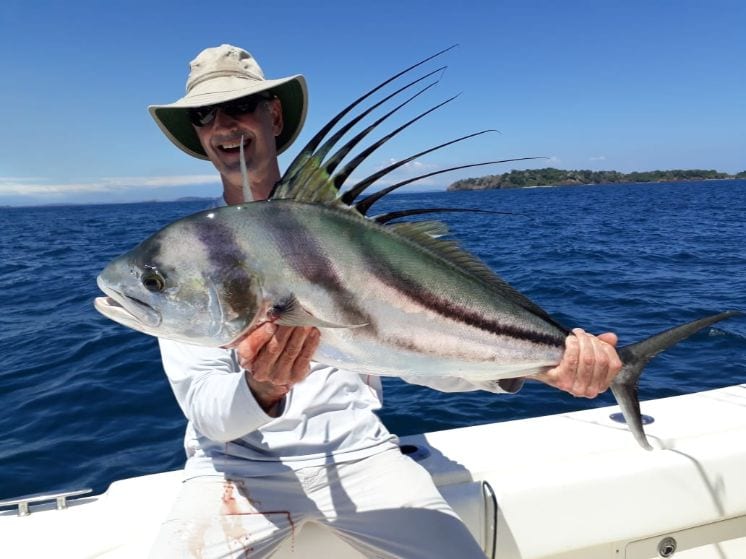 Angler holding roosterfish for photo op