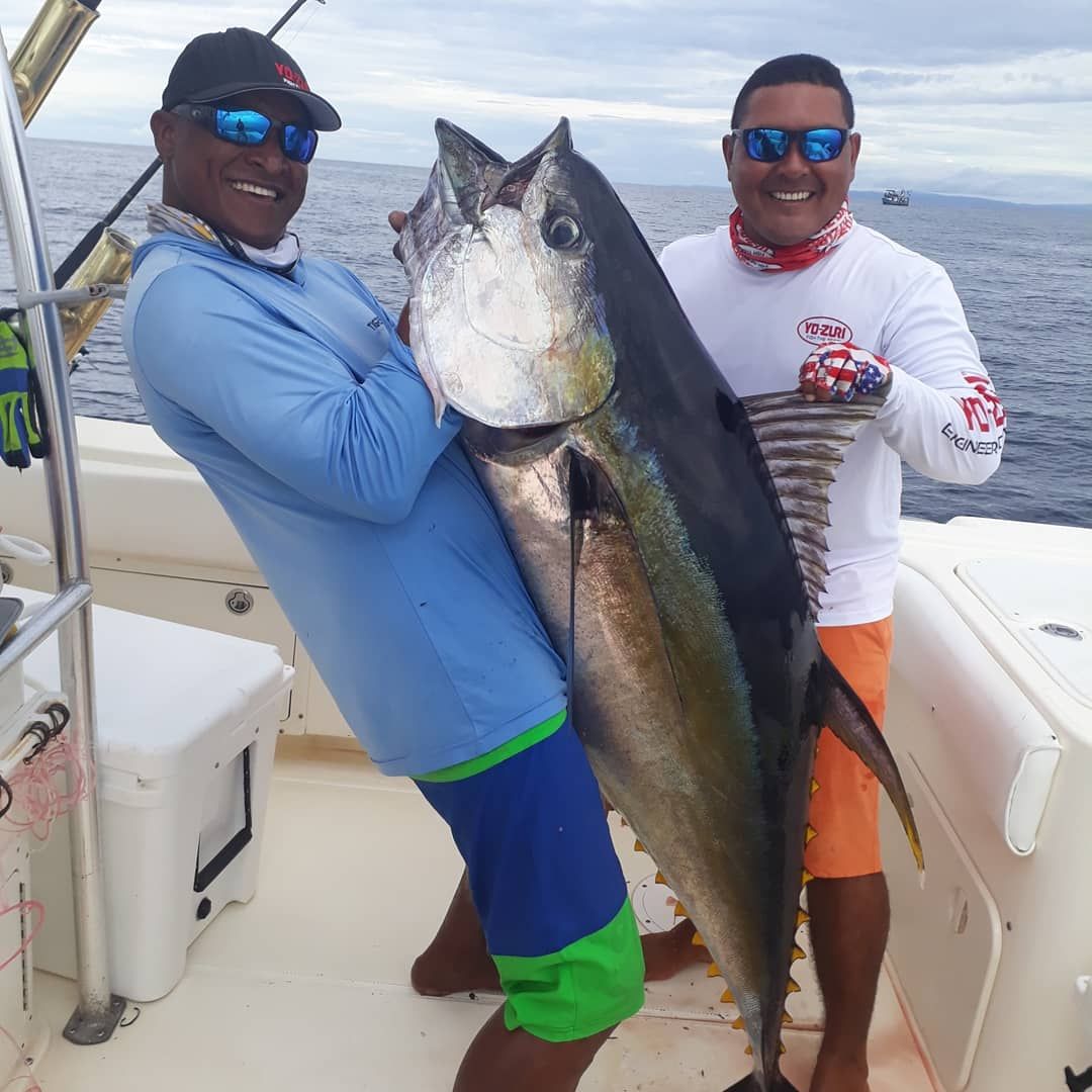 Capitan Juan, and mate posing with large yellowfin tuna