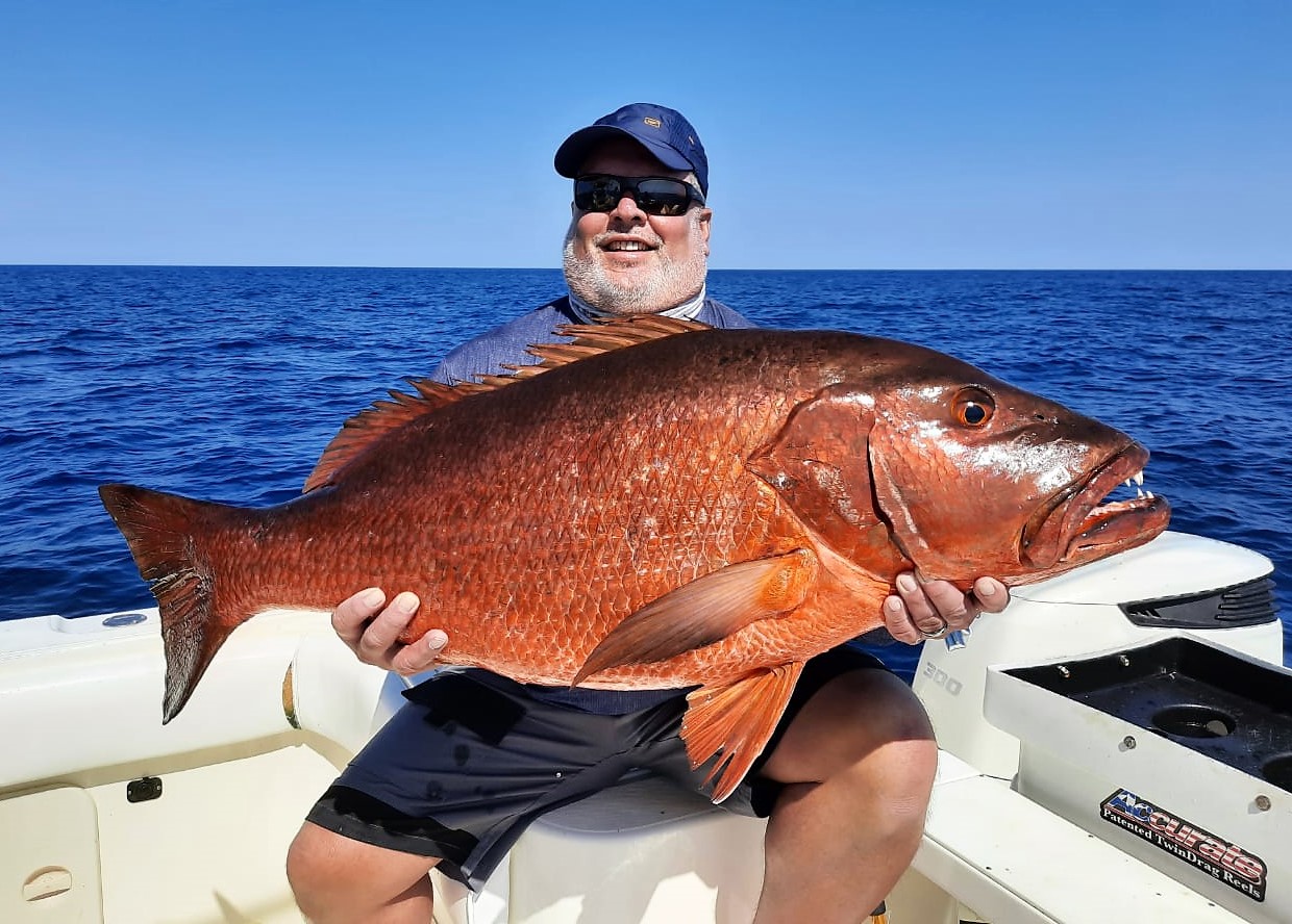 Angler holding large cubera snapper